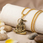 Lord Hanuman Golden Pendant With Chain with a warrior figure on a white fabric.