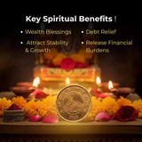 Gold coin with religious symbols on a table with flowers and candles.