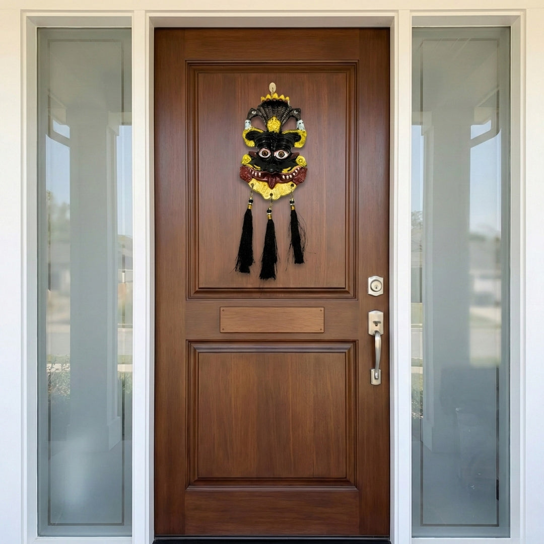 Wooden front door with decorative mask hanging on a house exterior