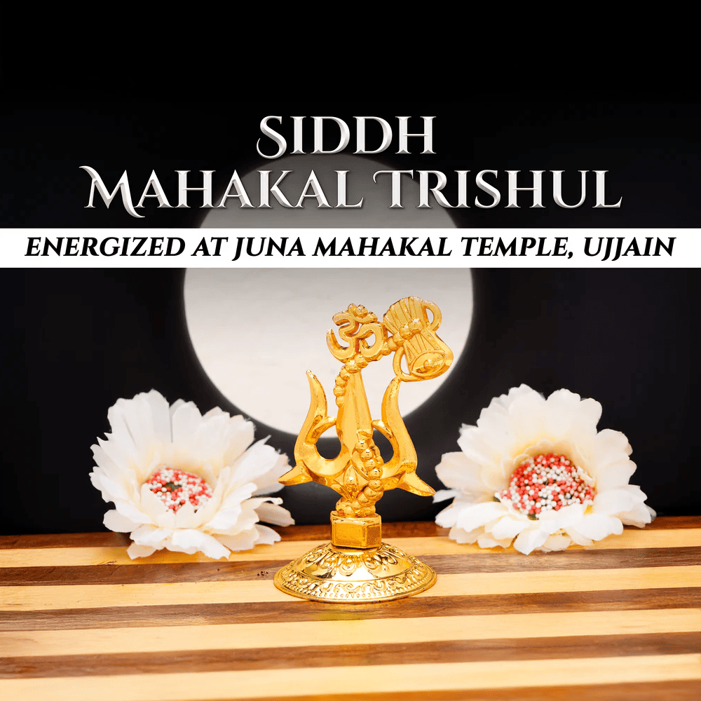 Gold trishul with white flowers on a wooden  featuring text about Siddh Mahakal Trishul.