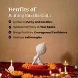 Bajrang Raksha Gada with decorative elements on a red cloth against a beige background