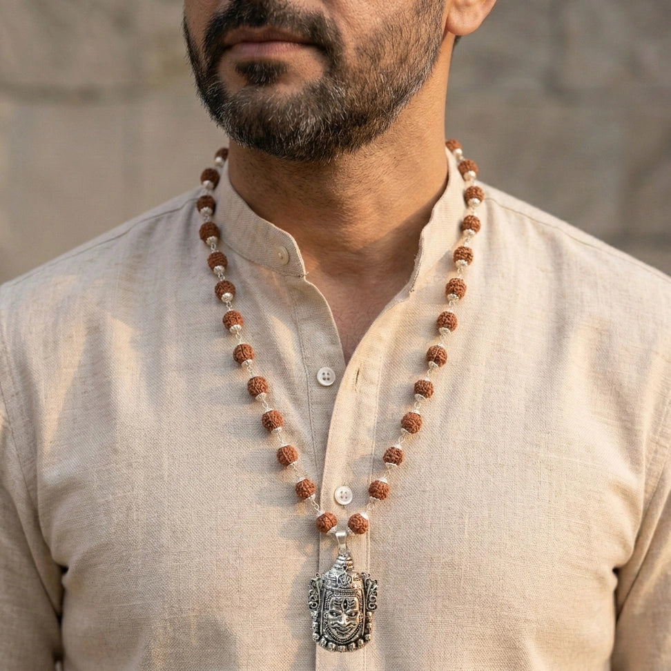 Man wearing a beaded necklace.