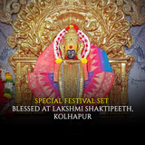 Decorative statue with colorful drapery and gold throne, text indicating special festival set blessed.