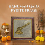 Framed Hanuman Gada Pyrite Frame on a wooden surface with decorative elements.