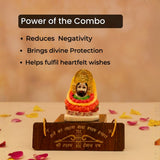Decorative statue with a wooden base on a beige surface with flower petals.