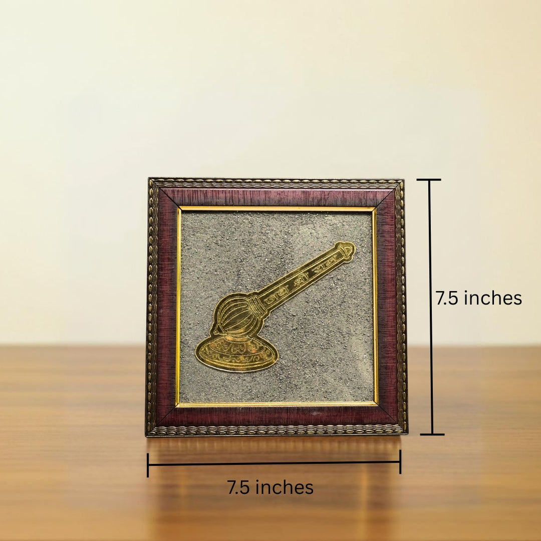 Framed artwork with a gavel on a wooden surface and beige background
