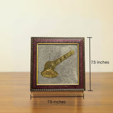Framed artwork with a gavel on a wooden surface and beige background