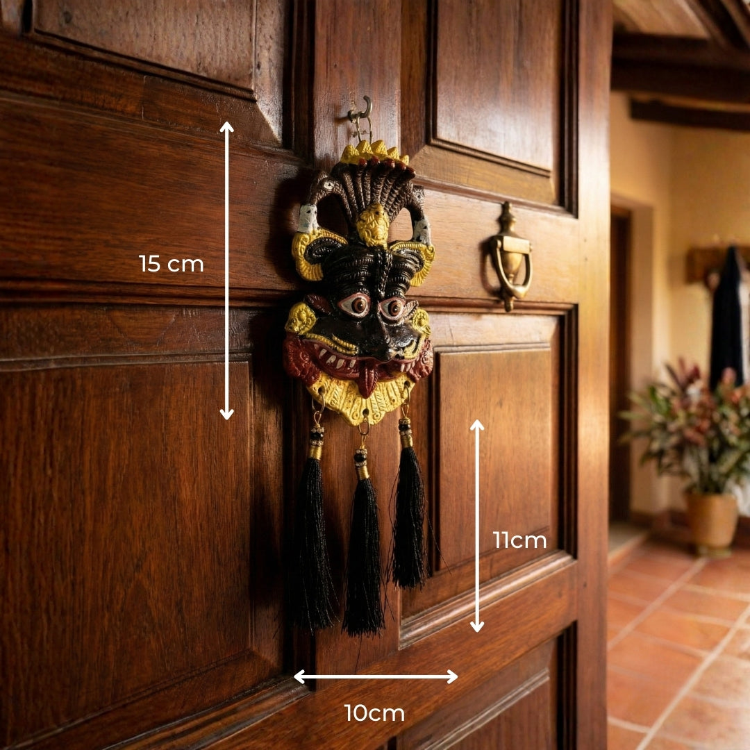 Decorative door knocker on a wooden door with measurements indicated
