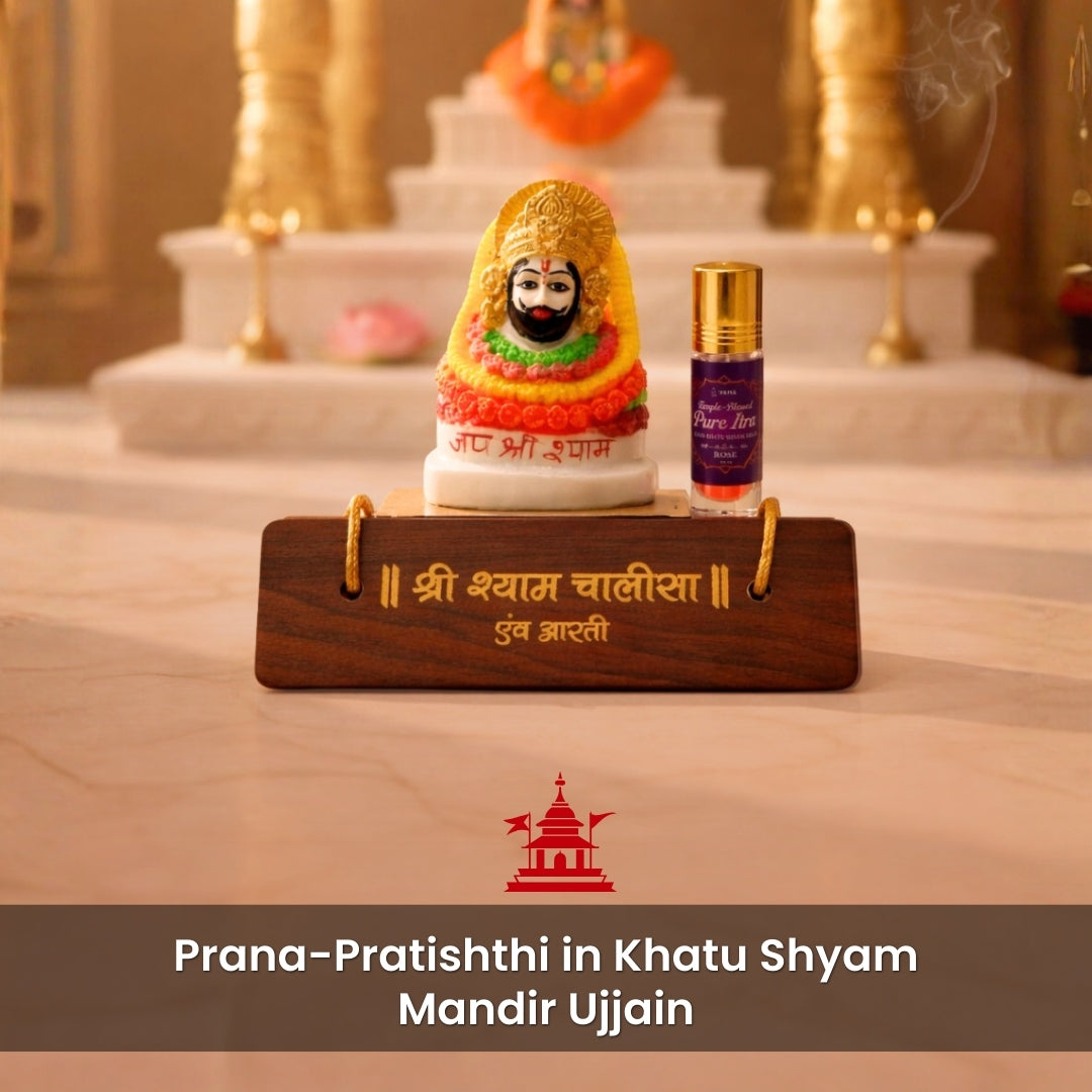 Small statue on a wooden stand with a purple bottle, set against a blurred background.