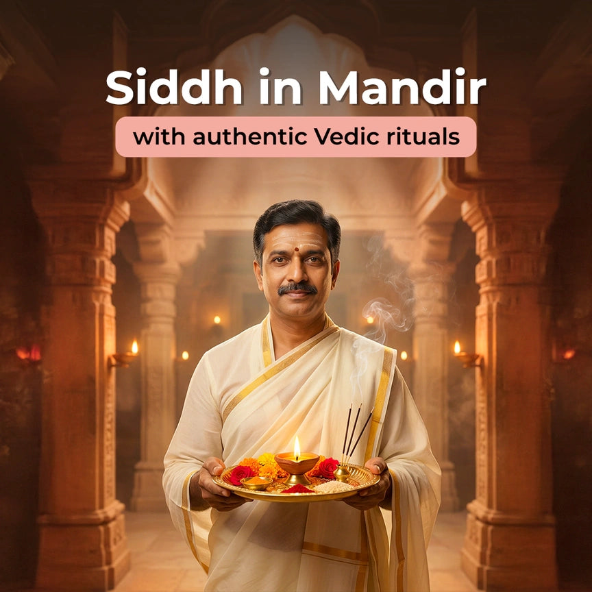 Man in traditional attire holding a plate with offerings in a temple setting
