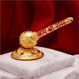 Gold-colored gavel with engraved text on a red background