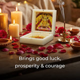 Decorative setup with candles, rose petals, and a small shrine on a wooden surface.