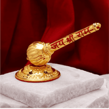 Gold-colored mace on a white marble base with a red background