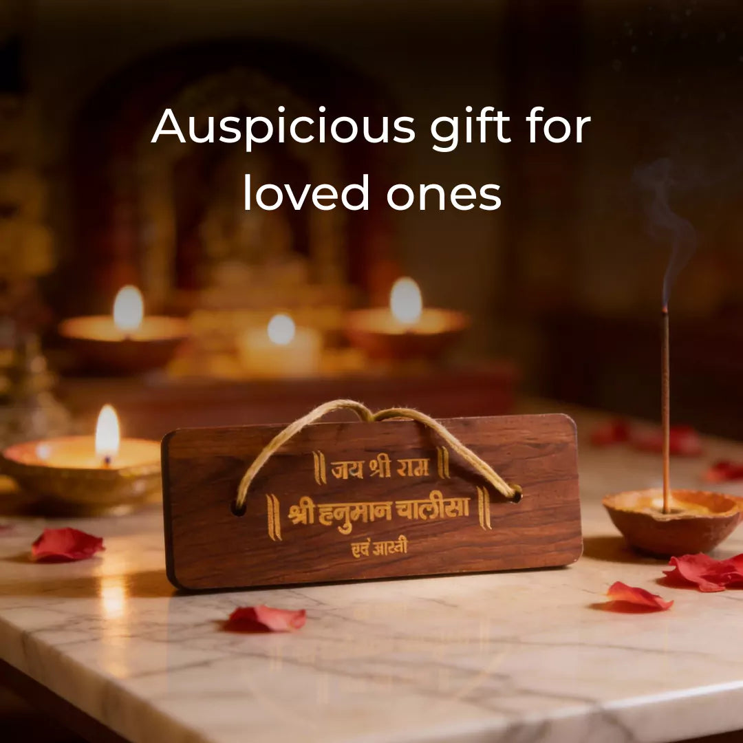Wooden plaque with engraved text on a table with candles.