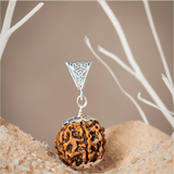 Silver pendant with a textured brown sphere on a neutral background
