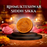 Rinmukteshwar Siddh Sikka with flowers, and lights in the background.