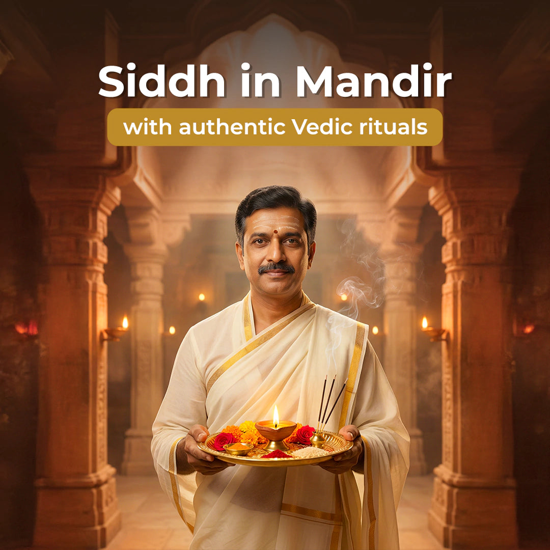 Man in traditional attire holding a plate with offerings in a temple setting