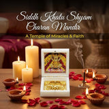 Decorative setup with candles, flowers, and a religious icon at Siddh Khatu Shyam Charan Mandir.