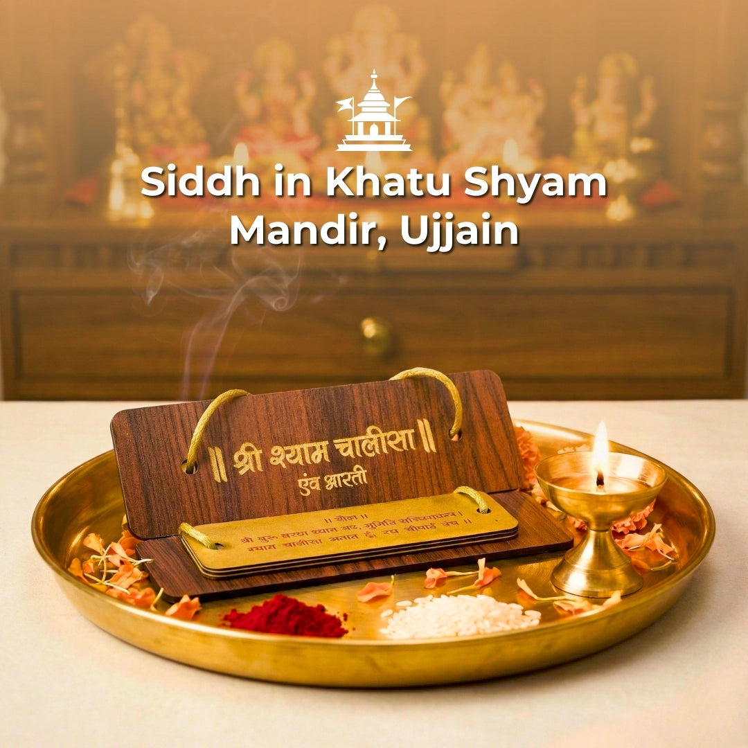 Siddh in Khatu Shyam Mandir, Ujjain with wooden plaque and lit candle on a tray.