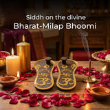Two pairs of sandals with Om symbols on a wooden surface.