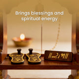 Wooden foot washbasin with sandals and a candle in a warm setting