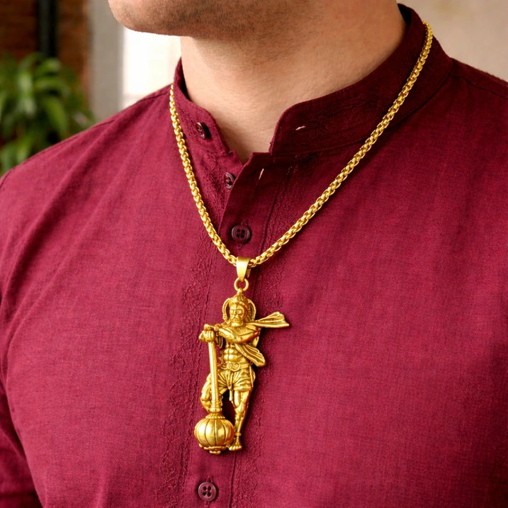 Gold hanuman gadda necklace with a pendant.