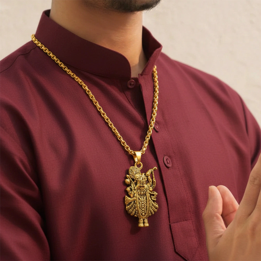 Man wearing Golden Lord Krishna Silver Pendant with a gold necklace.
